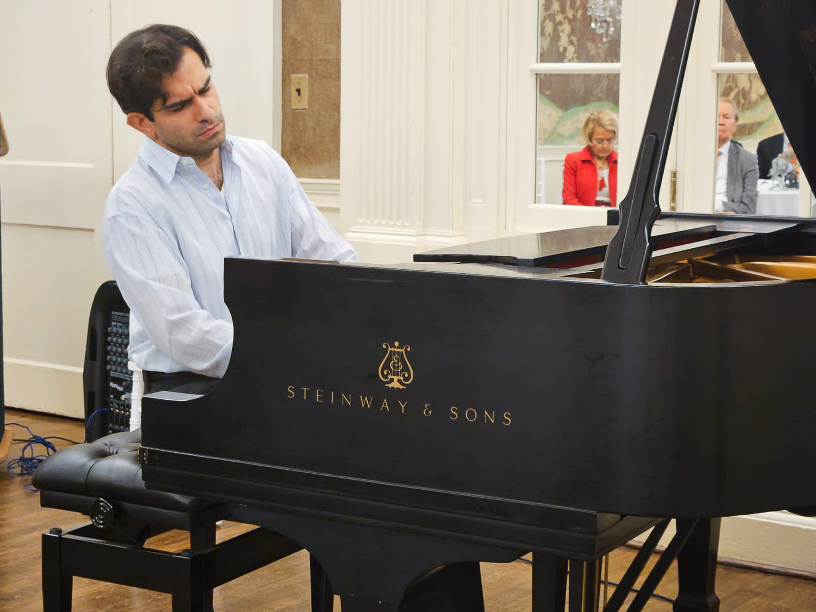 Pianist performing at a Steinway during the WIPAC finals